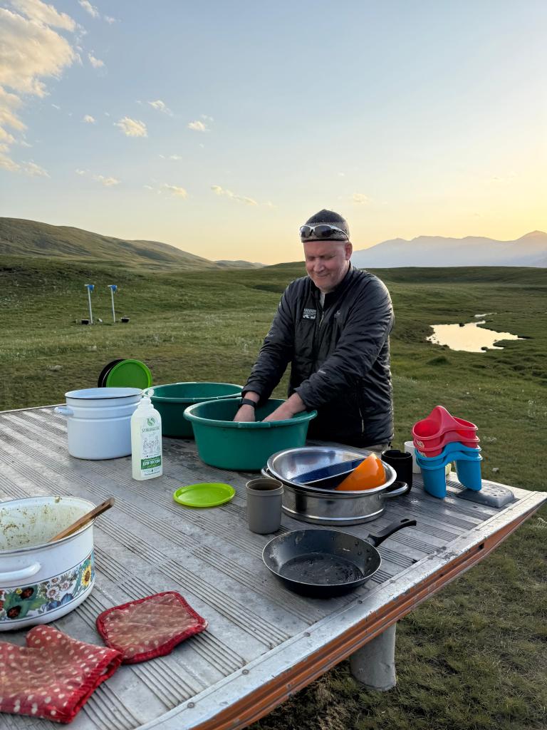 Man doing the dishes in the open
