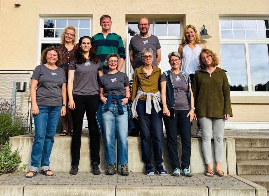 A group of people standing in front of a house
