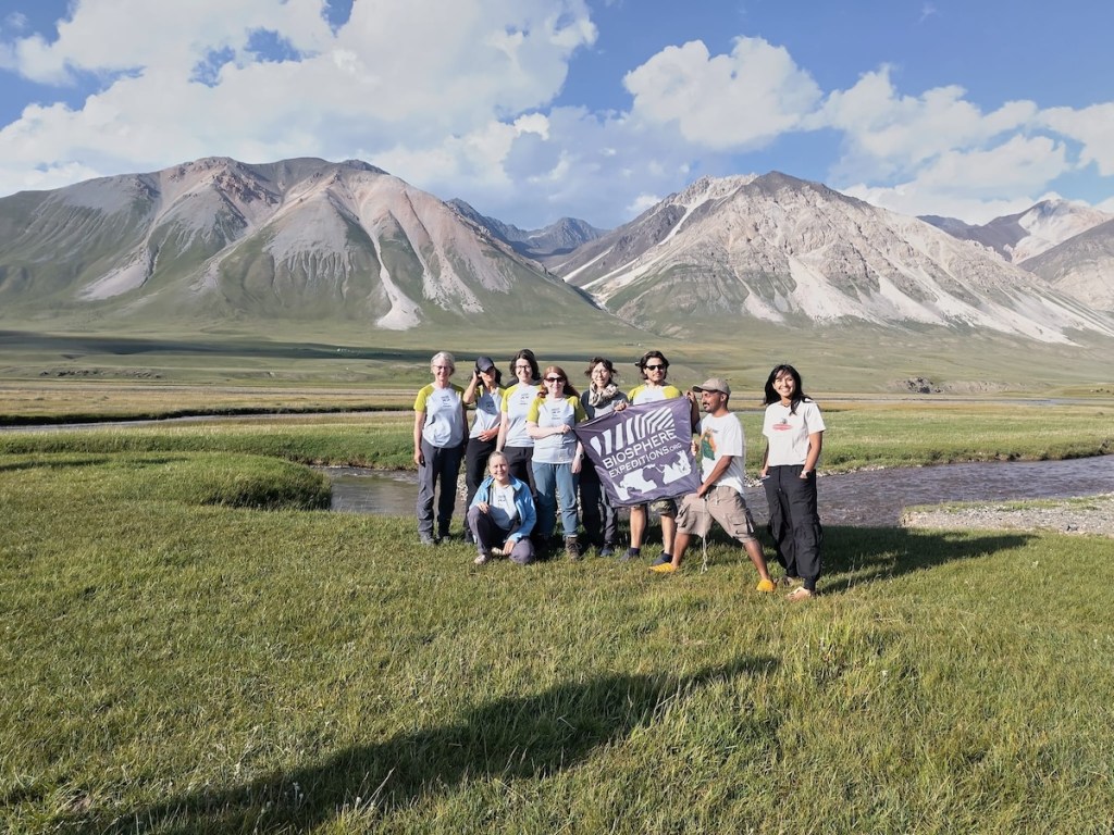 A group of people standing in a mountain valley