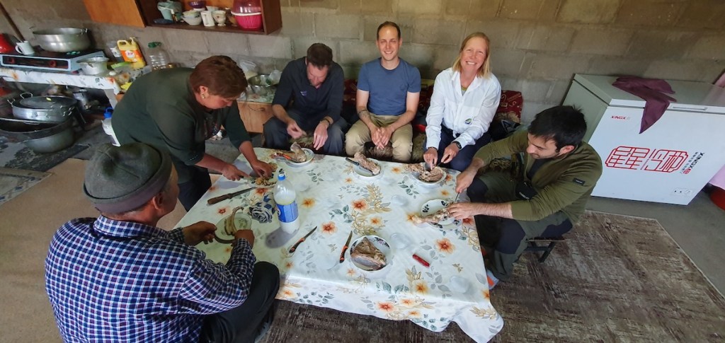 A group of people setting round a table