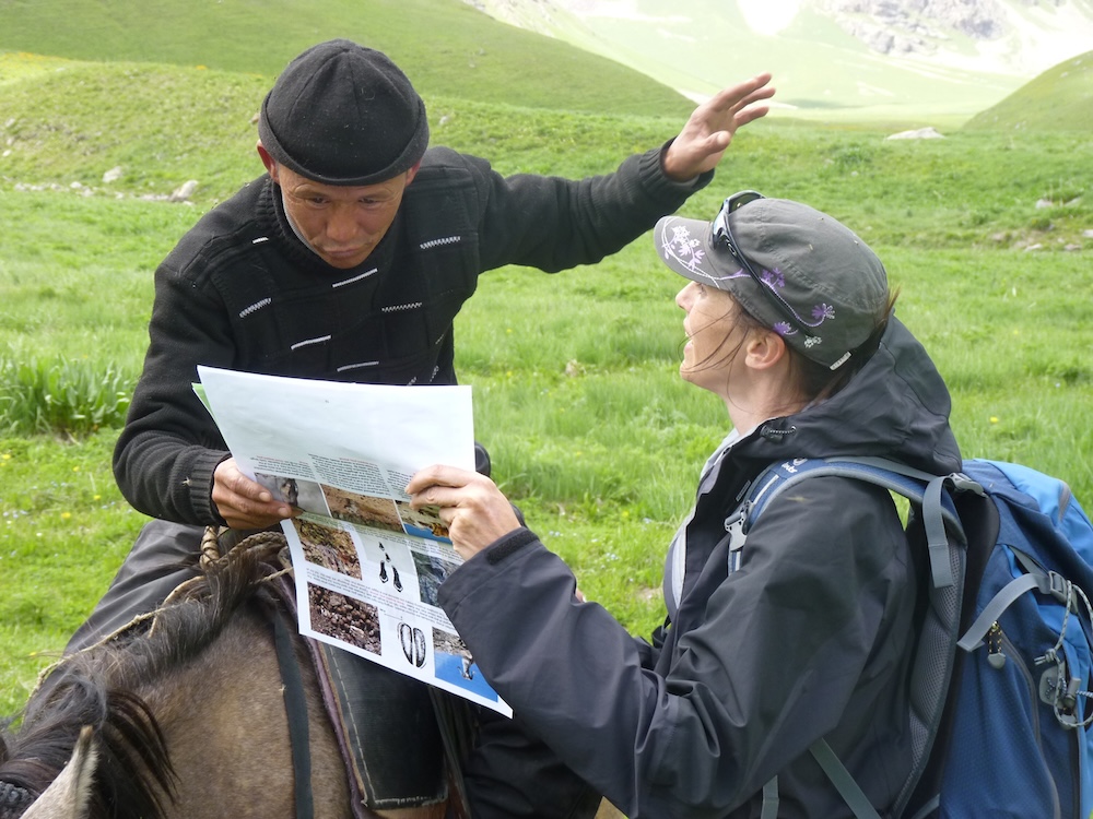 A woman talking to a man on horseback